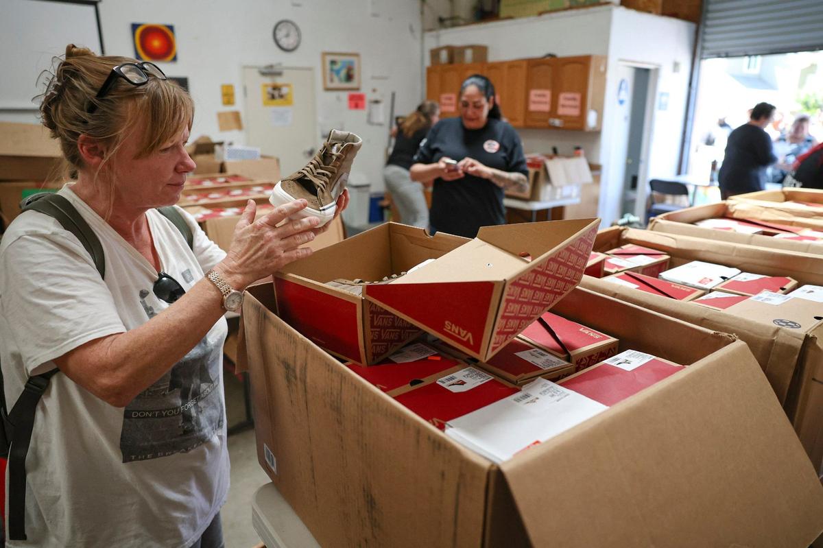 Sherry Van Valkenburgh picks out a pair of tennis shoes as Vans and Transitions-Mental Health Association give away 1,500 free pairs of shoes in San Luis Obispo on April 30, 2024.