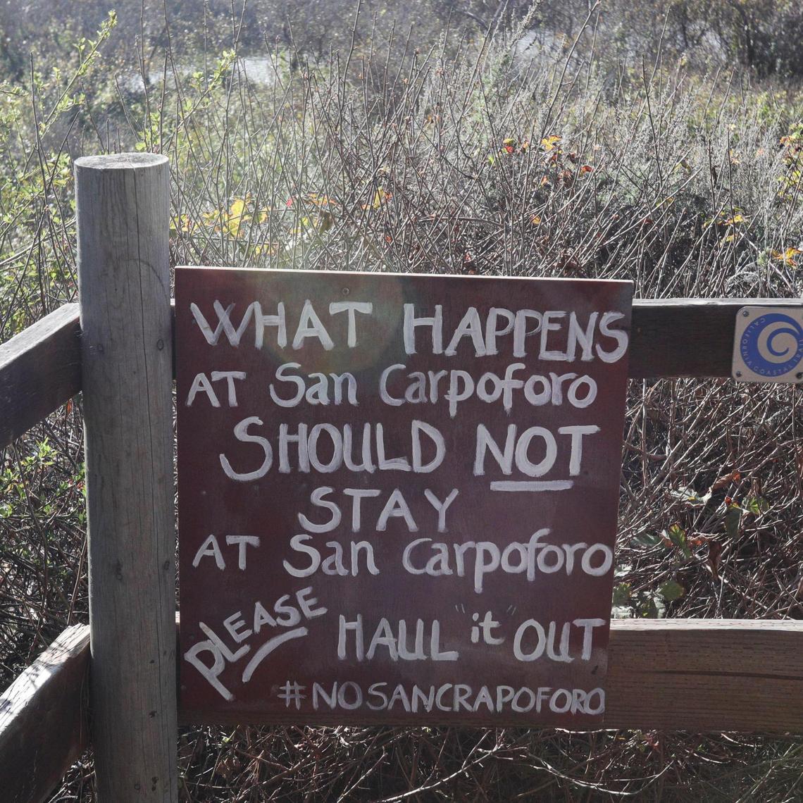 An unofficial sign at the highway asks people to pack out their trash. San Carpoforo Creek Beach has a small area managed by the U.S. Forest Service and in recent years campers have not respected the area leaving garbage and burning driftwood.