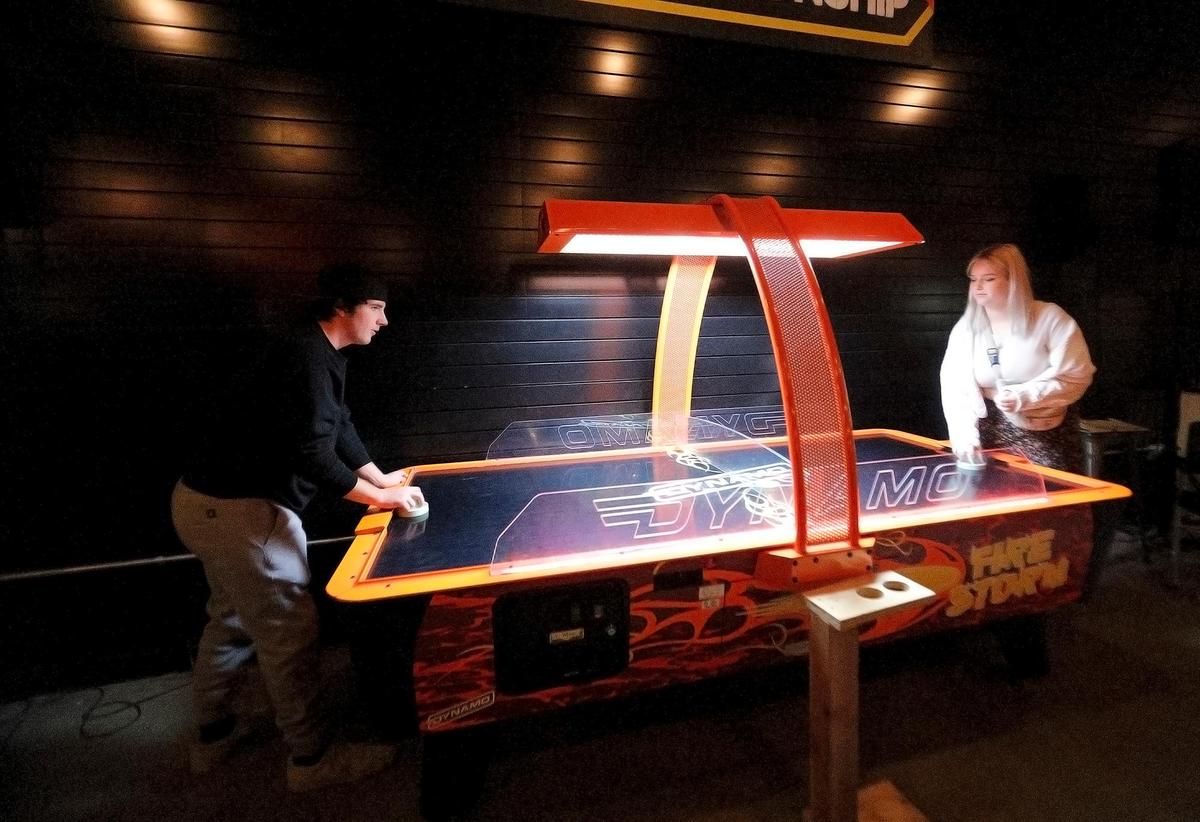 Blake Pimental of Arroyo Grande and Georgia Green of Templeton play air hockey at BA Start Arcade Bar in downtown San Luis Obispo. The “barcade” offers food, drinks and a range of games for customers to enjoy.