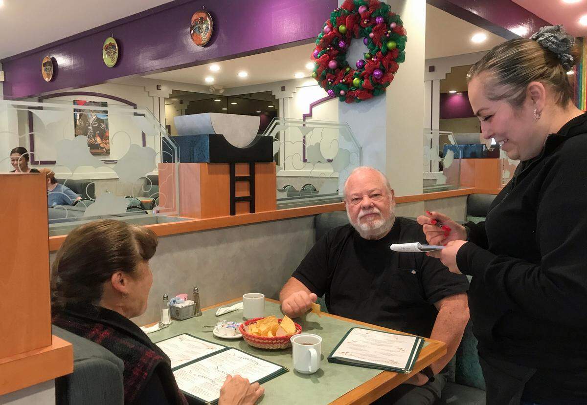 From left, Ruthie and Bob Ashton of Los Osos order their breakfasts during their first visit to the new La Katrina Cocina. Taking their order is their friend Wendy Morales, the restaurant’s co-owner.