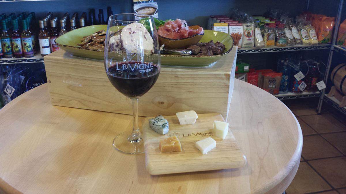 A cheese sampler is paired with a glass of wine and other goodies at Le Vigne Winery's tasting room in Paso Robles.