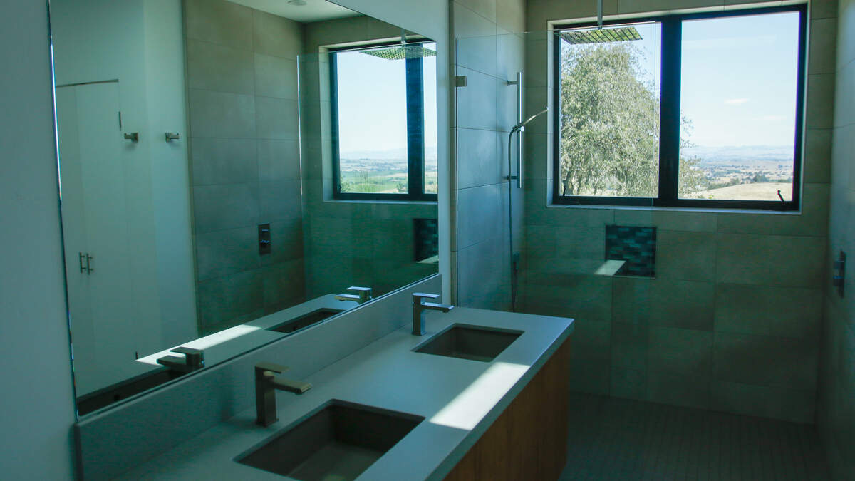 The bathroom of an estate currently up for sale at 705 Sequoia Lane overlooks the nearby hills on Wednesday, June 10, 2026. The 12-acre estate near Templeton features the first commercial planting of Nero di Troia grapevines — native to Italy’s Puglia region — in the United States.