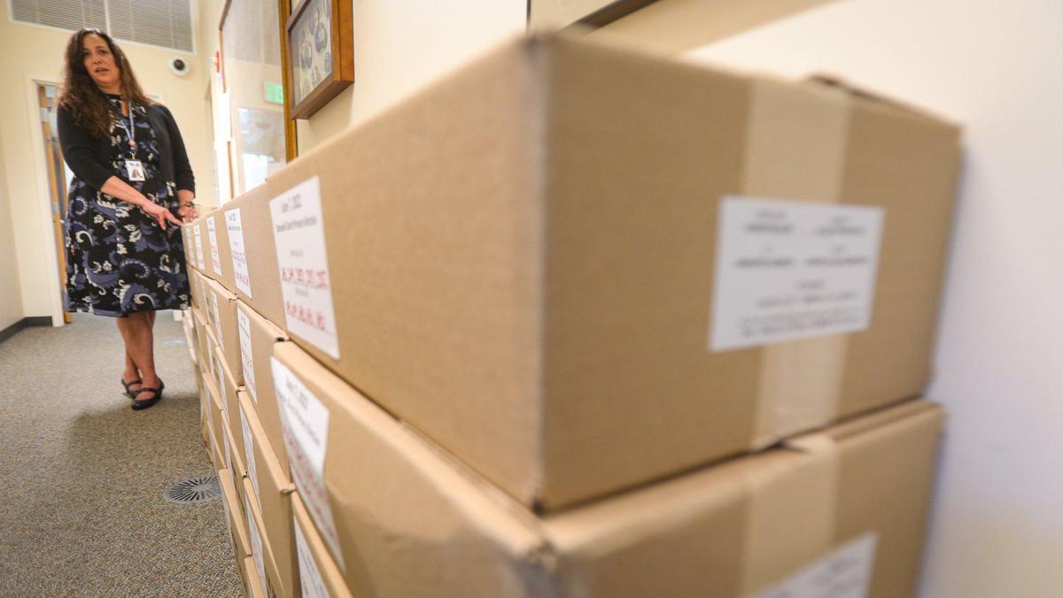 Elaina Cano, San Luis Obispo County clerk-recorder, shows boxes of mail-in envelopes that must be stored for almost two years after the election, as vote-counting proceeded on Tuesday, June 14, 2022.