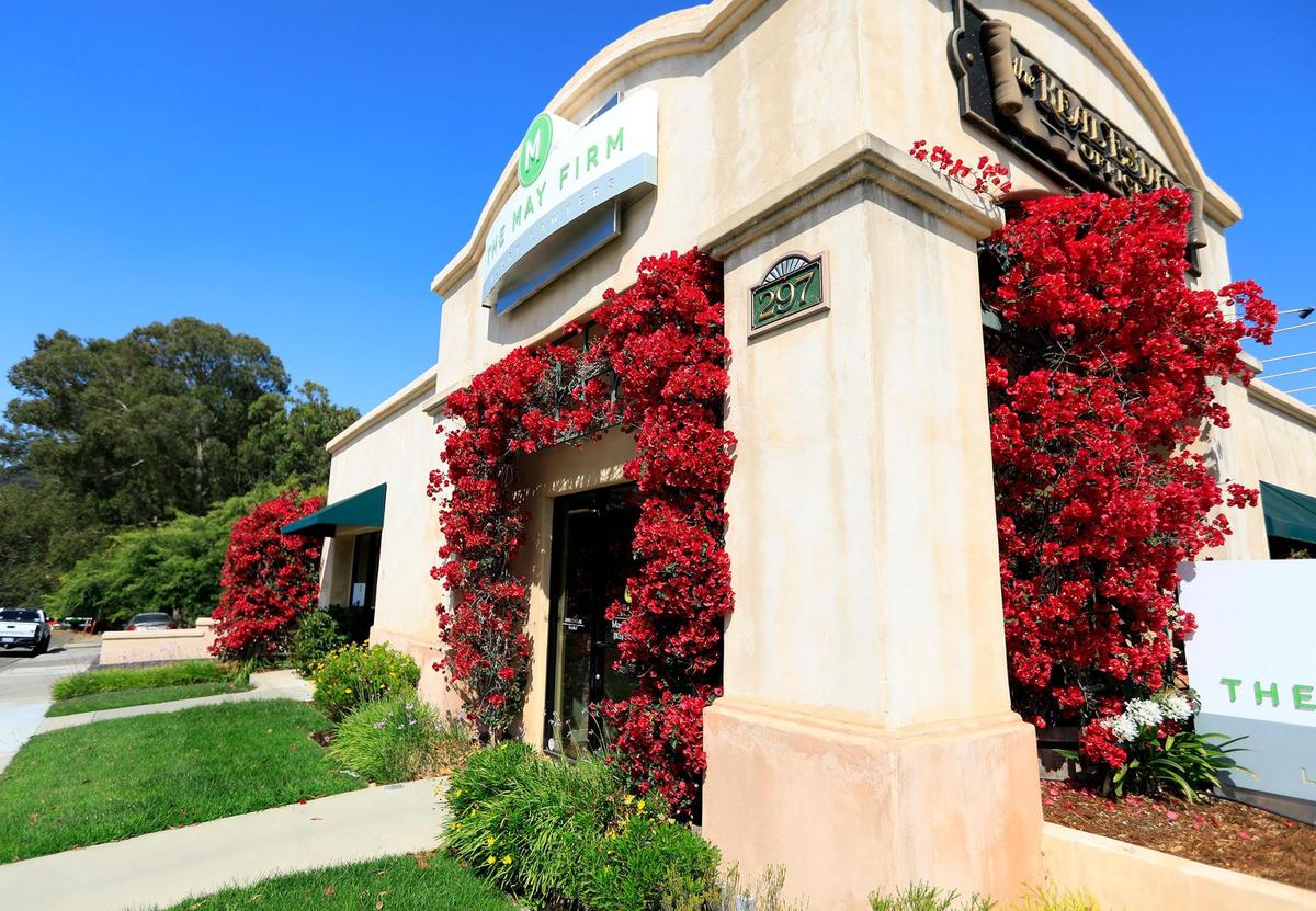 Beautiful bougainvillea bushes drape the doors and windows of The May Firm and The Real Estate Office on Santa Rosa Road in San Luis Obispo.