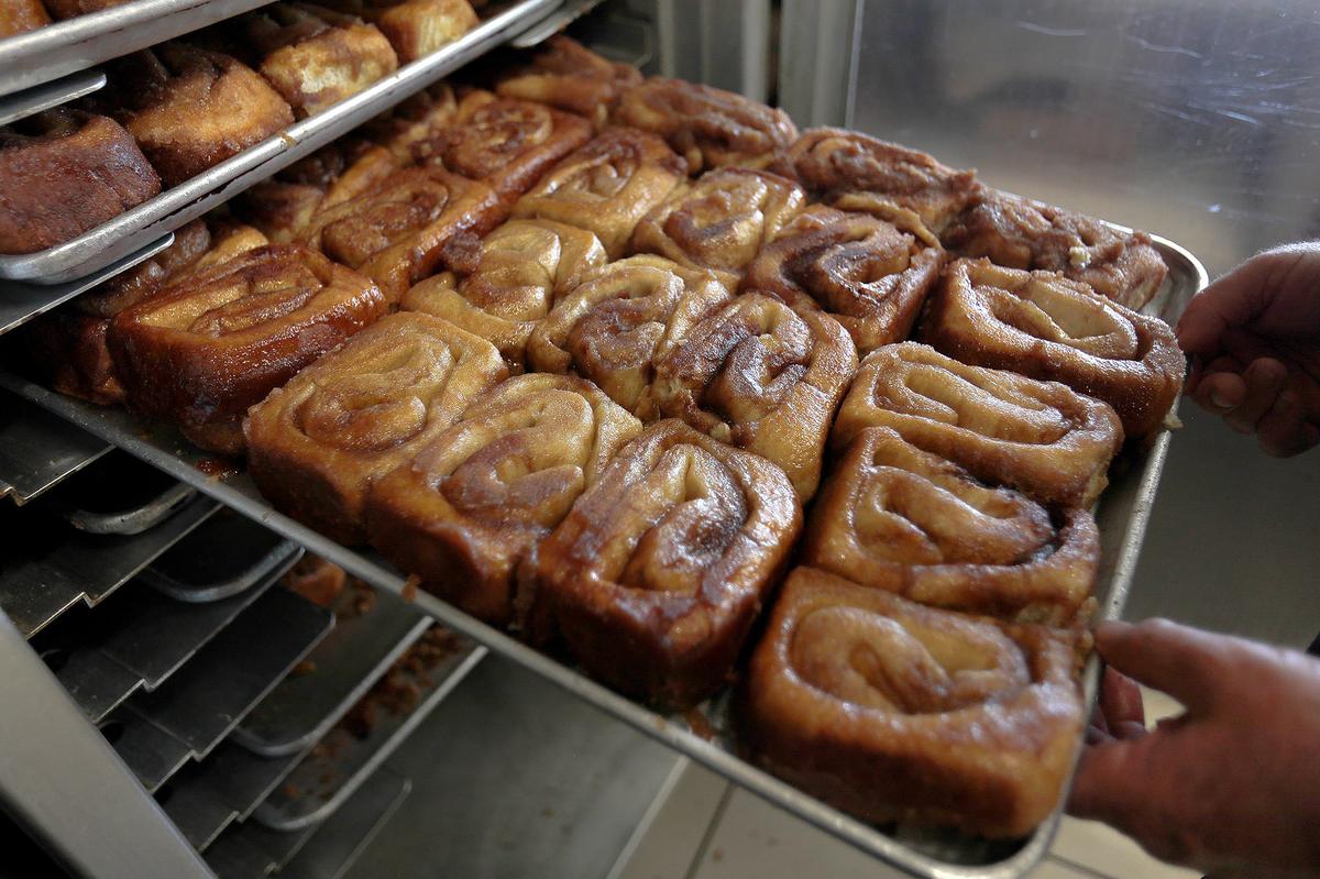 A fresh batch of cinnamon rolls comes out of the oven at Old West Cinnamon Rolls in Pismo Beach.