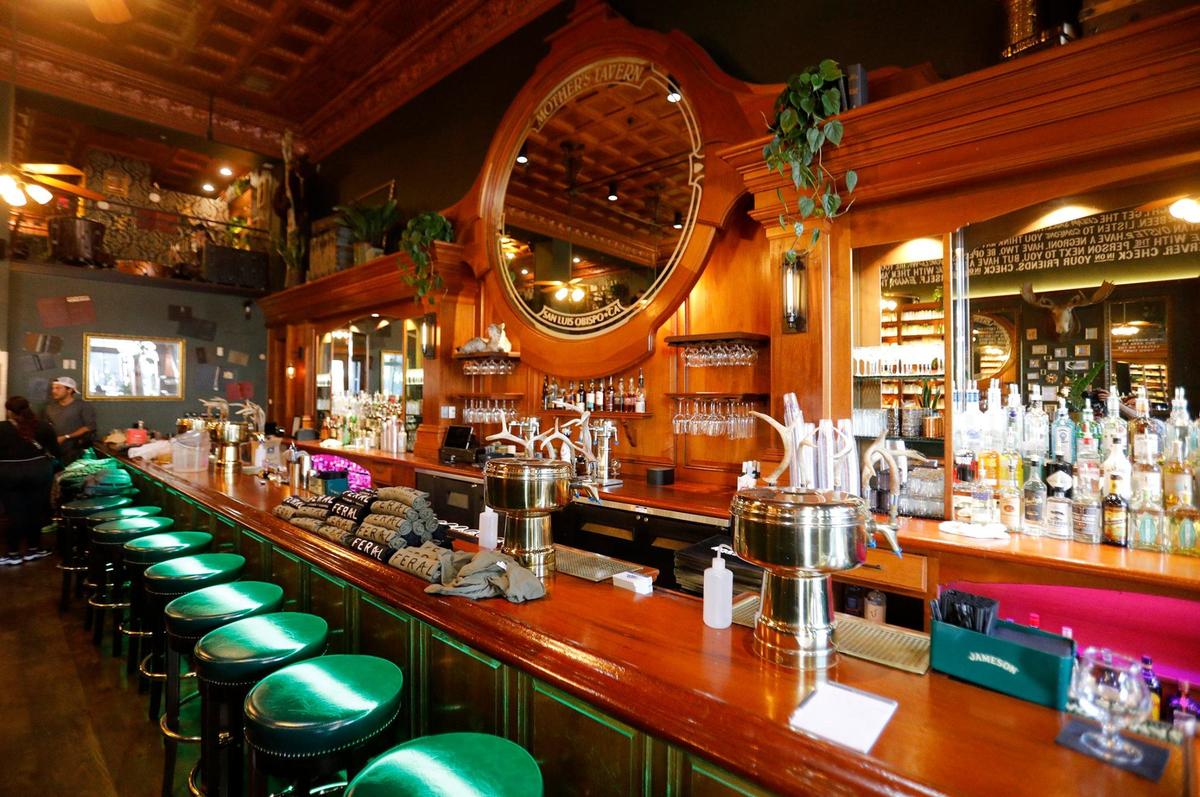 Feral Kitchen + Lounge took over the Mother’s Tavern space in downtown San Luis Obispo, California. The business has retained the mirror behind the bar with the business’s previous name.