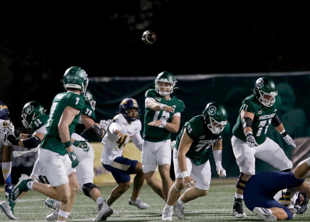 Cal Poly quarterback Jackson Akins lobs as pass. Cal Poly lost to Northern Arizona 31–14 in a college football game at Mustang Memorial Field on Nov. 9, 2024.