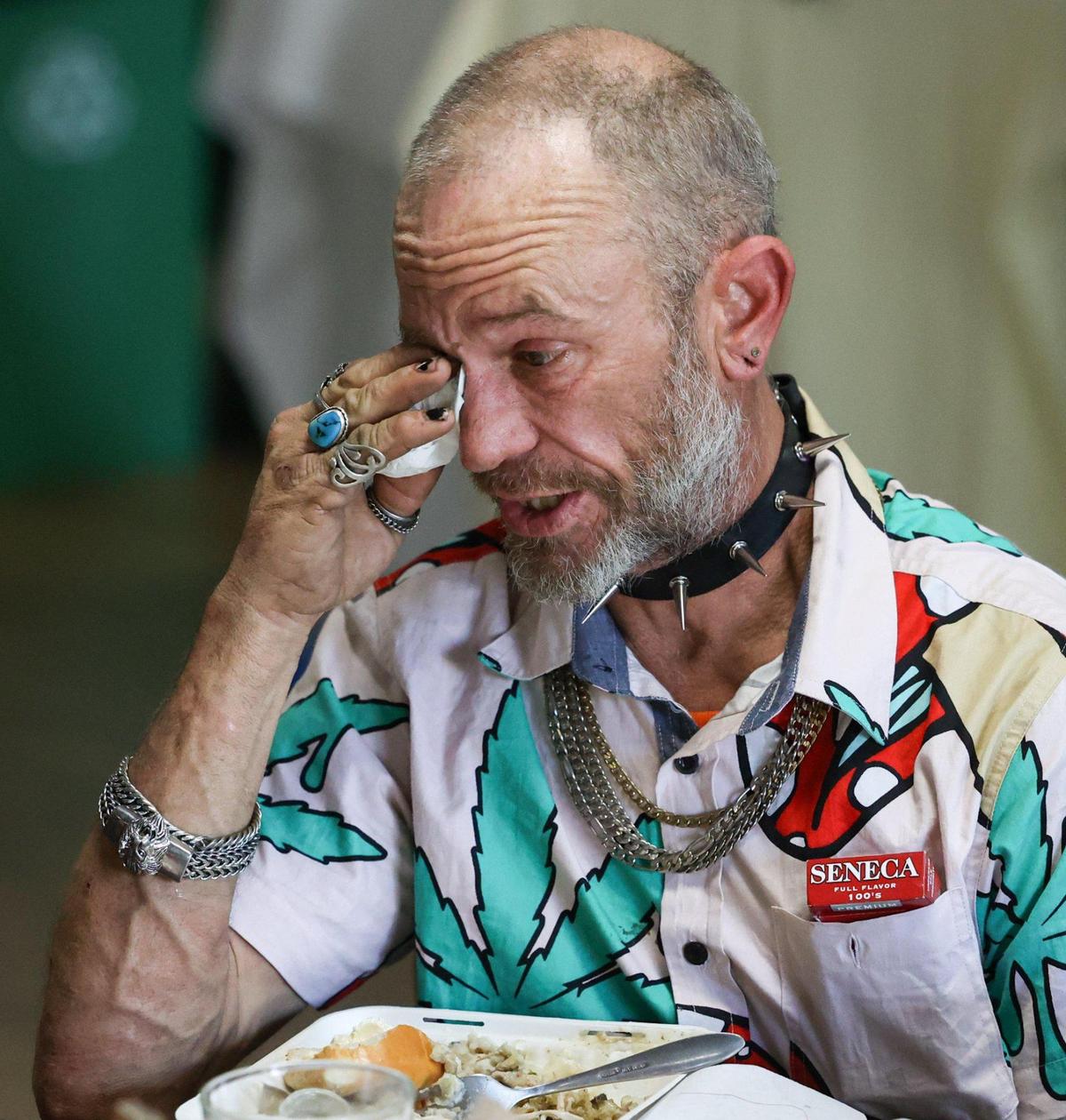 Preacher Eugene Cothren wipes away tears as he gives thanks at the Community Thanksgiving Dinner served Wednesday, Nov. 22, 2022, at the Elks Lodge in San Luis Obispo. Over 1,500 meals were served or delivered.