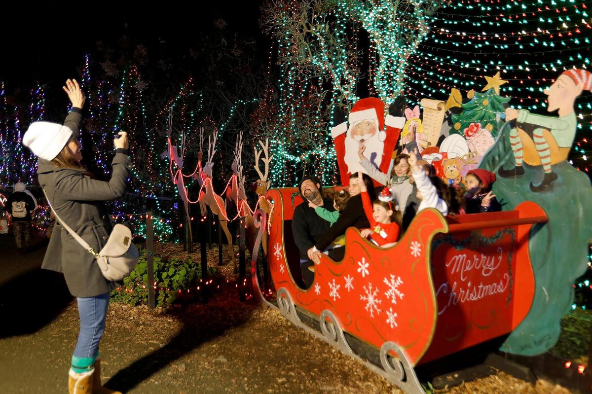 CambriaÕs Christmas Market is opened business as usual Dec. 14, 2022. A family piles into SantaÕs Sleigh to take a photo.