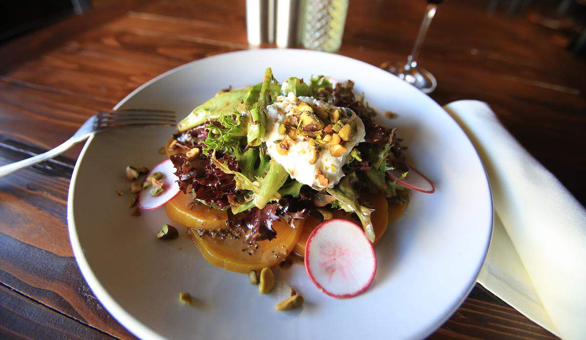 Café della Via’s roasted beet and radish salad features mixed greens, stracciatella and pistachios splashed with a balsamic vinaigrette.