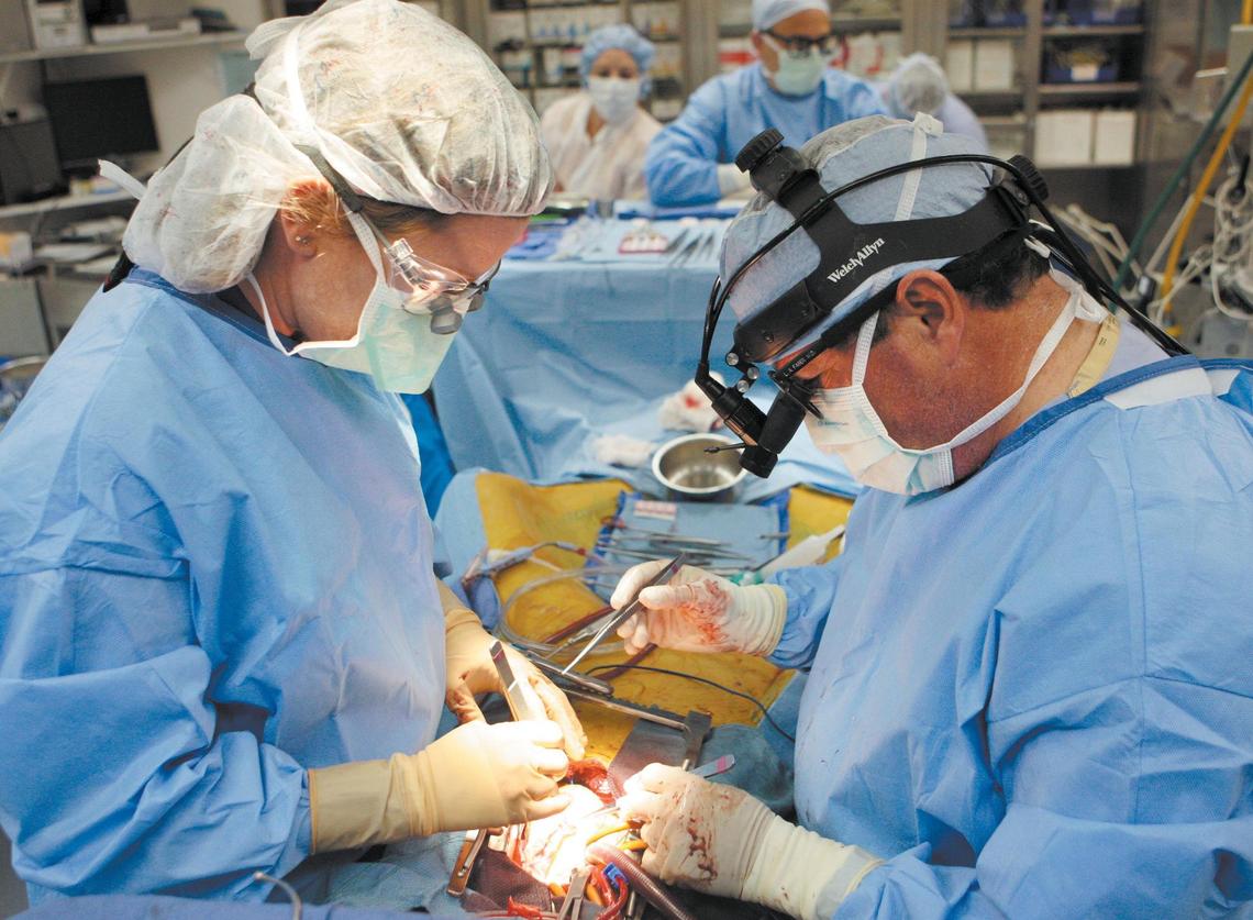 A heart bypass surgery at French Hospital Medical Center in San Luis Obispo involves cardiac surgeon Dr. Luke Faber, registered nurse Kathie Flynn and, the background, cardiac surgeon Dr. David Canvasser on June 25, 2008. Joe McDermott is the heart patient.