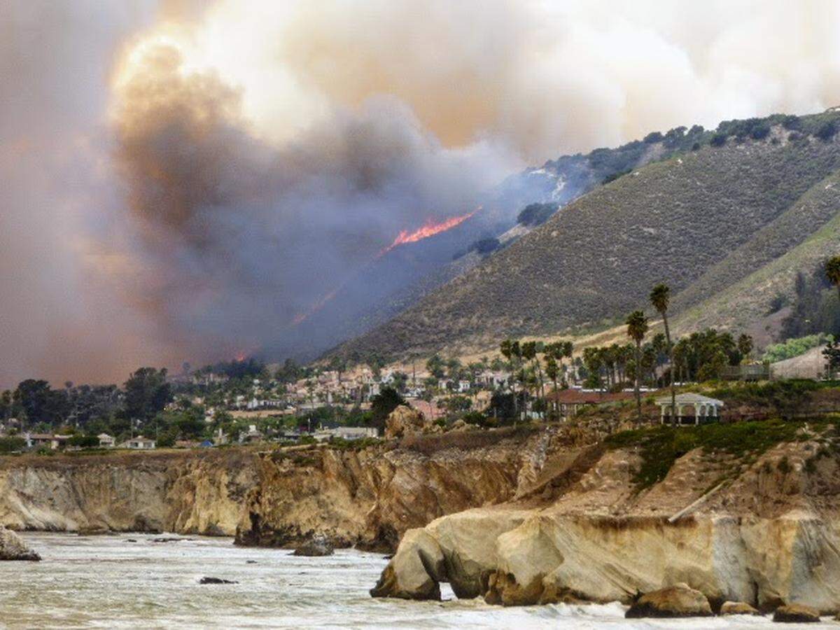 The Avila Fire burns in the hills above Shell Beach on Monday, forcing evacuations from nearby homes.