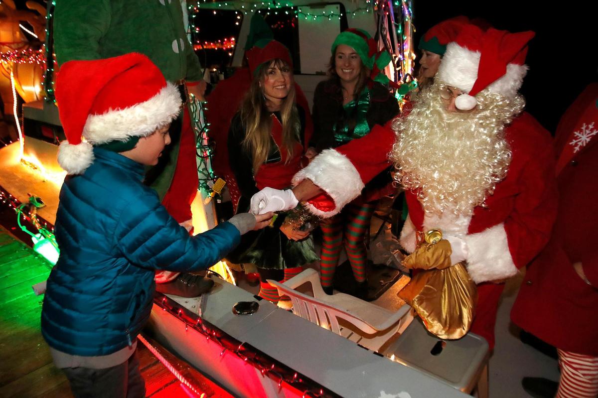 Mike Handy played Santa Claus and handed out candy to Howie Hultgen, 11 of Ventura. The fishing vessel “Persistence” owned by Nick Taron was all decked out for Lighted Boat Parade in Morro Bay Harbor, Saturday, Dec.4, 2021.