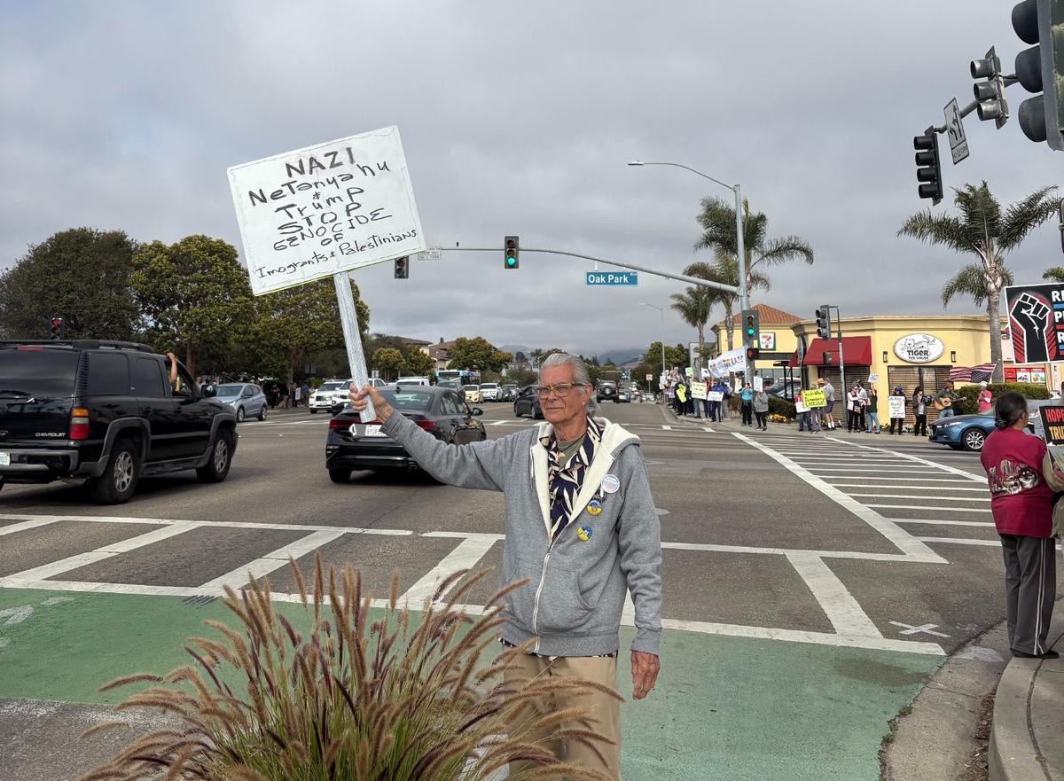 Alfonso Ugalde waved a sign during a “Good Trouble” protest on the corner of Oak Park Boulevard and Grand Avenue in Arroyo Grande on July 17, 2025. 