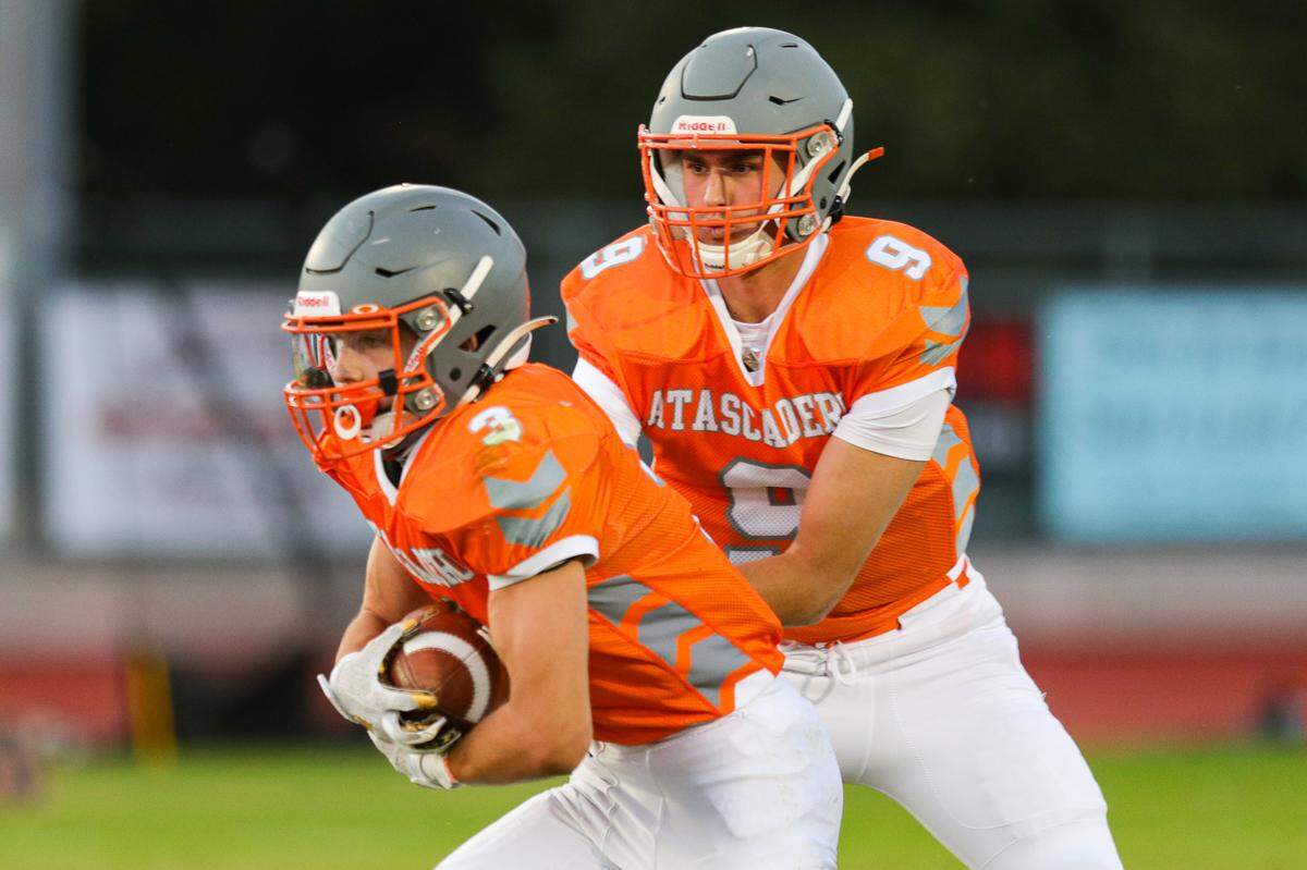 Evan Moscardi hands off to Cole Tanner. Atascadero hosted Paso Robles for the traditional rivalry as the final game of the season last spring.