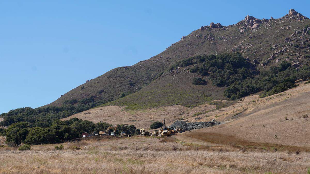 Mining vehicles harvest Franciscan melange, a stone found at the base of Bishop’s Peak, from a quarry on Foothill Boulevard Thursday, Aug. 15, 2024. The quarry sits on Madonna Ranch land and is supplying materials for John Madonna Construction’s Highway 1 repair efforts at Big Sur Lookout.