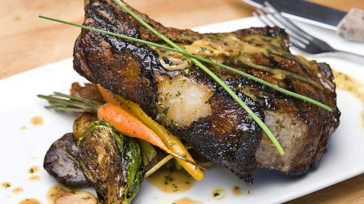 A market-cut, 32-ounce ribeye steak is served with garlic mashed potatoes, baby heirloom carrots and Brussels sprouts at Sidecar.