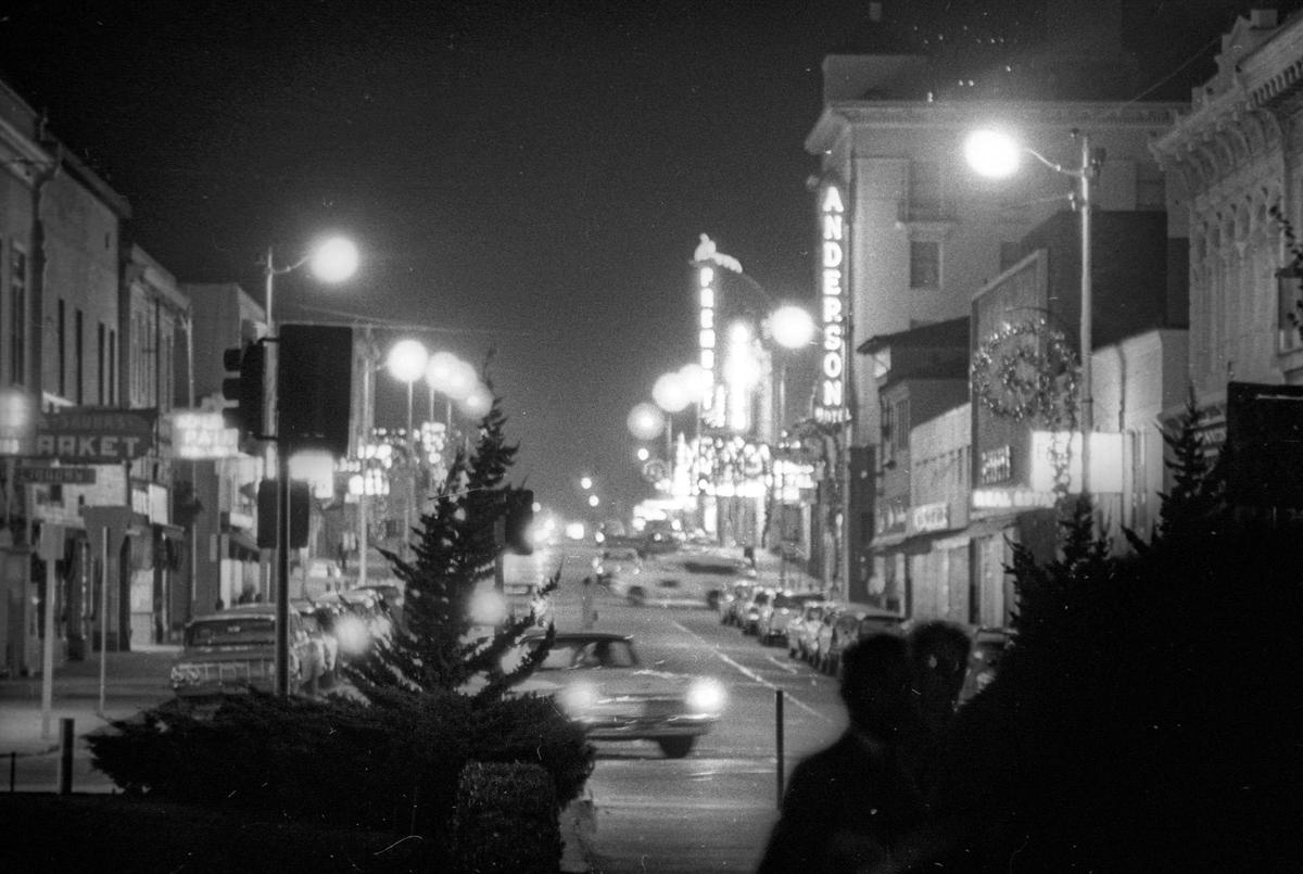 Monterey Street looking east from Mission. (Mission Plaza was not built yet) Dec. 18, 1963, at night. Anderson Hotel and Obispo and Fremont Theaters.