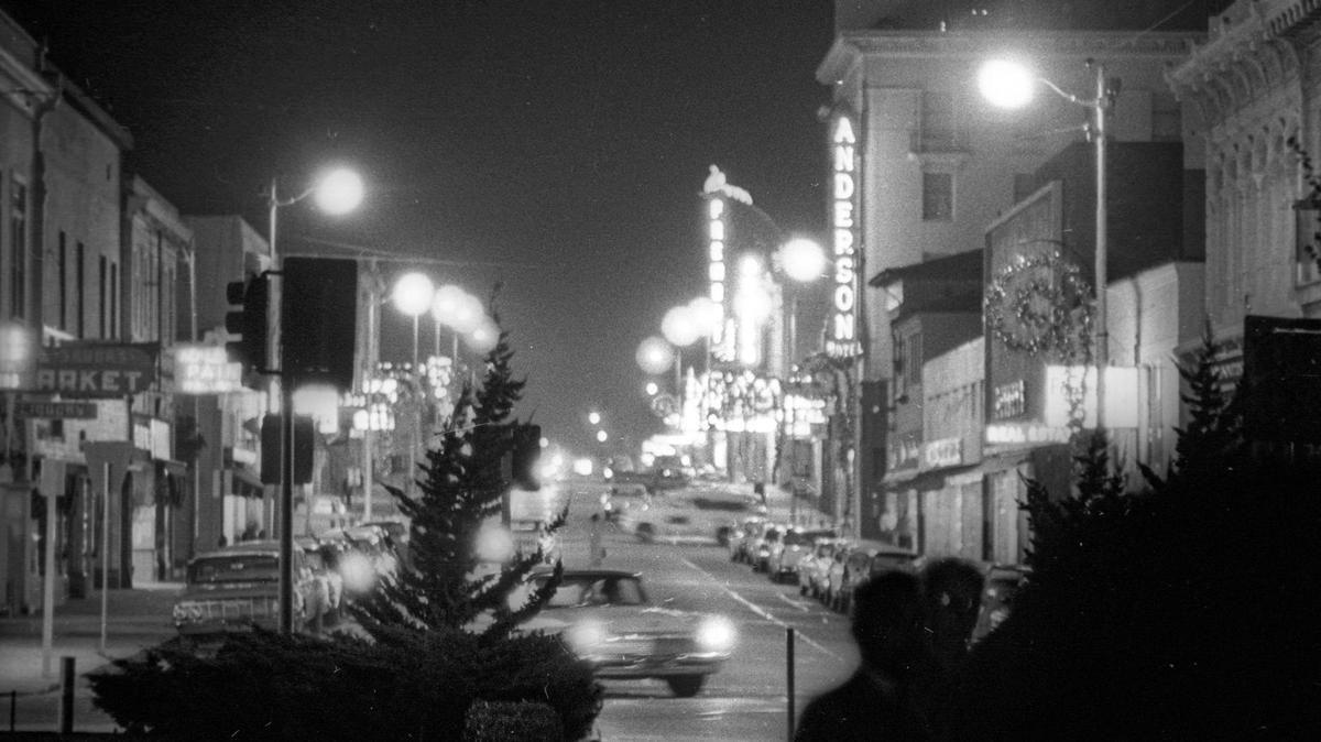 Monterey Street looking east from Mission. (Mission Plaza was not built yet) Dec. 18, 1963, at night. Anderson Hotel and Obispo and Fremont Theaters.