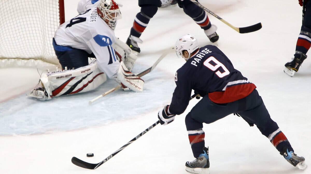 USA's Zach Parise pulls in the puck and shoots it for a goal against Finland's Miikka Kiprusoff. (George Bridges/MCT)