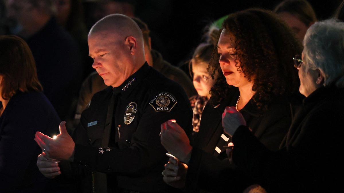 San Luis Obispo Police Chief Rick Scott and Mayor Erica Stewart lit candles as more than 200 people filled Mission Plaza on May 10, 2022, to remember San Luis Obispo police Det. Luca Benedetti. The officer died in the line of duty one year ago while serving a search warrant.