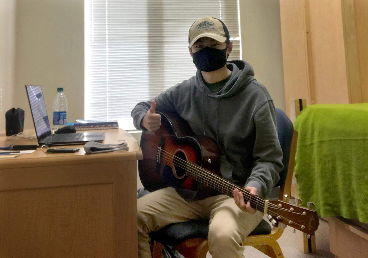 Second-year Cal Poly history major Ethan Yoon is one of 13 students placed in isolation after receiving false-positive COVID-19 tests. He said he was glad he thought to bring his guitar with him, but he’s eager for the isolation period to be over.