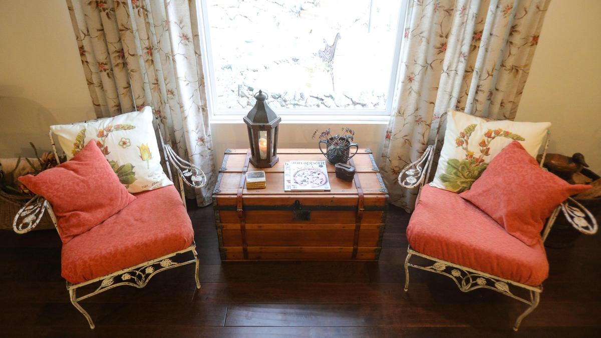 Ann Tye sewed new cushions for these antique wrought iron chairs, which sit in the living room of her Cambria home.
