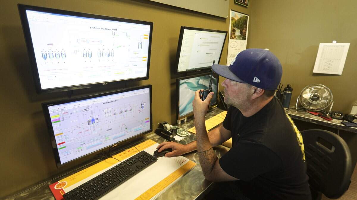 Dustin Kral, head brewer talks to a fellow brewer on the radio about the status of one of the batches. They have 5-6 core brews and dozens of specialty recipes. Scenes from the Firestone Walker brewery in Paso Robles, seen here on April 14, 2026.