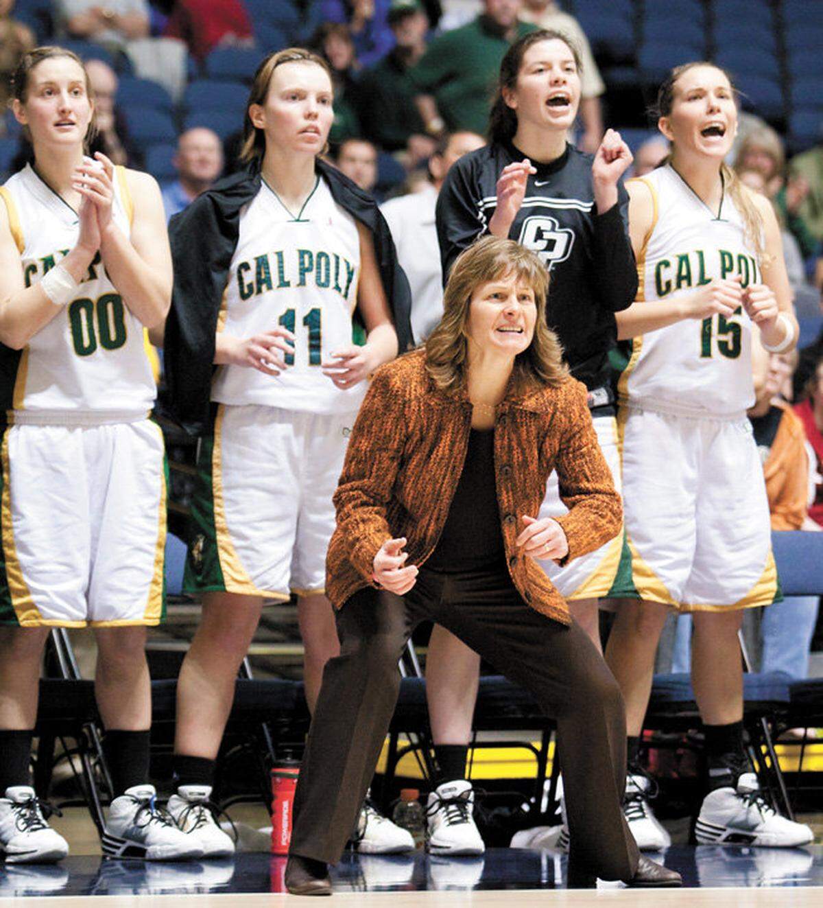 Cal Poly head coach Faith Mimnaugh and the bench cheer as Cal Poly rallied in 2010 Big West Conference tournament game against UC Riverside. Minmaugh is in her 24th year as the Mustangs’ head coach.