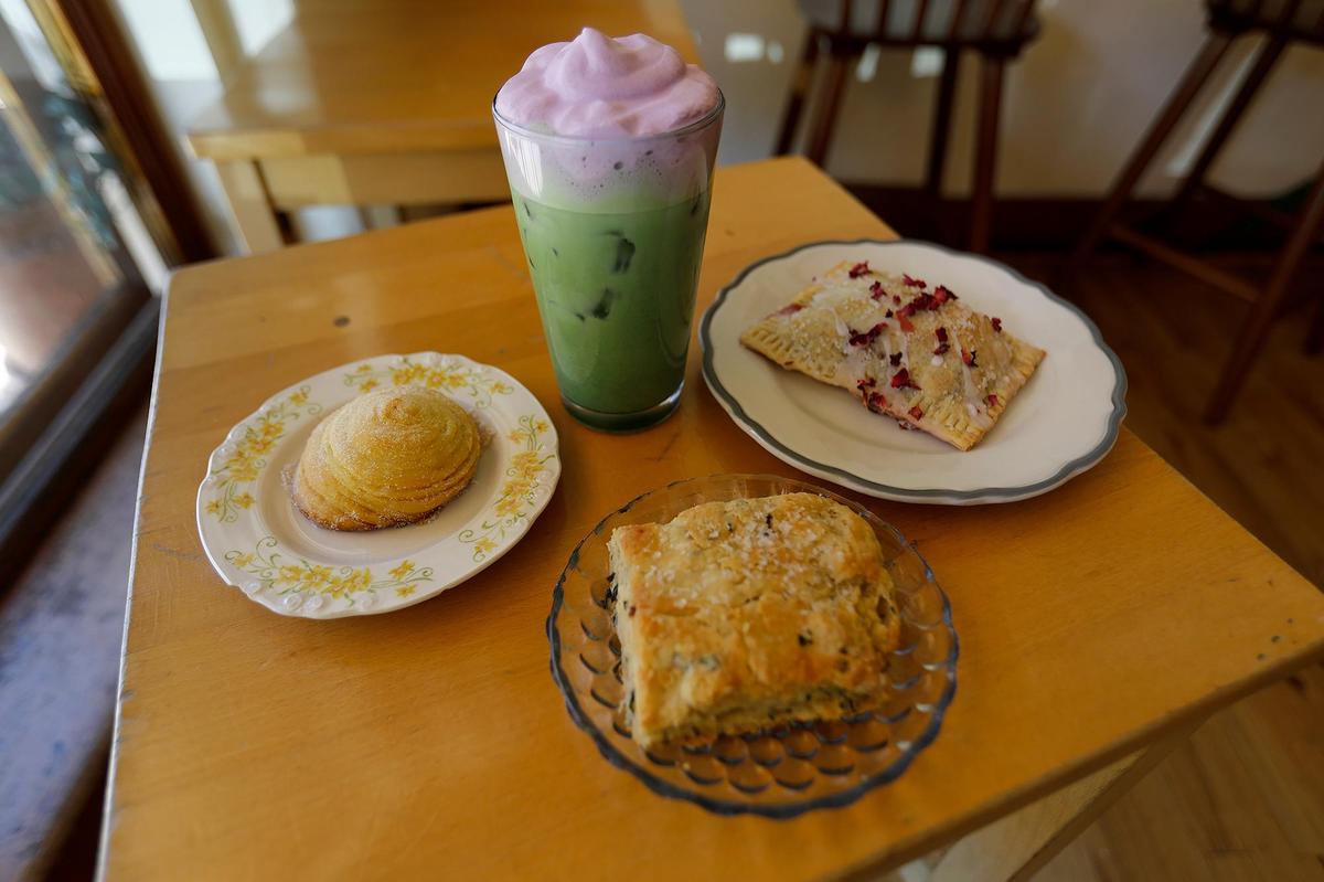 Pictured next to iced vanilla matcha ube with cold foam is a saffron bun (left), garlic-and-chive biscuit and blueberry pop tart. The iconic Linnaea’s Cafe in San Luis Obispo has been owned by Rusty and Alex Quirk, husband and wife team, since 2023.