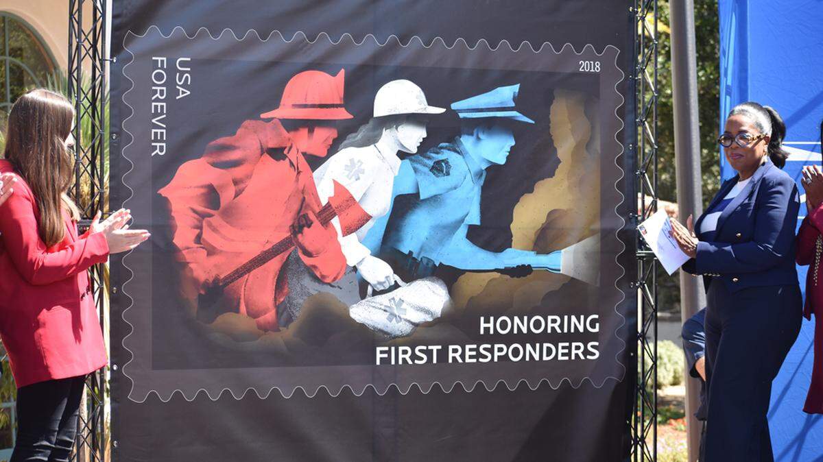 Oprah Winfrey stands alongside Lauren Cantin, left, a mudslide survivor, during a U.S. Postal Service stamp dedication ceremony held at the Montecito Fire Department on Friday.