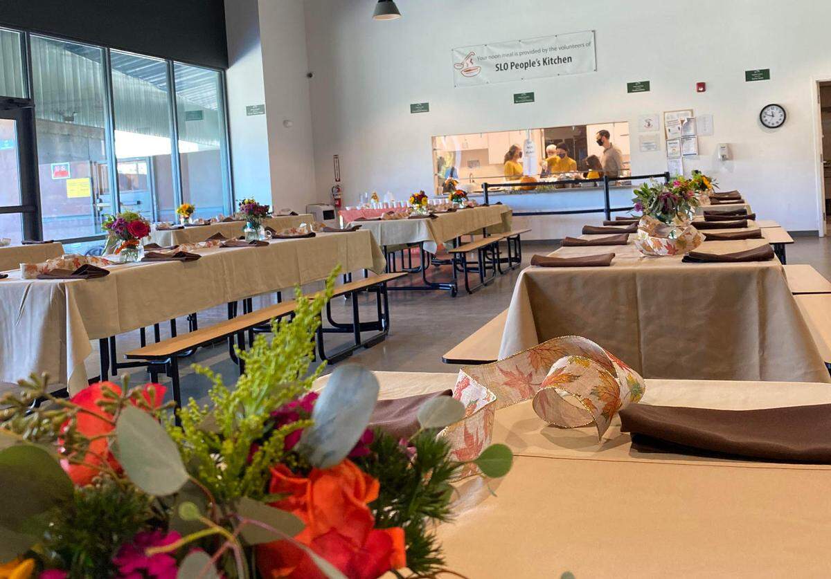 Tables in the 40 Prado Homeless Shelter dining hall are decorated with a Thanksgiving spread by the People’s Kitchen of San Luis Obispo in 2021. The volunteer organizations serves guests at 40 Prado 364 days a year, except for Christmas.