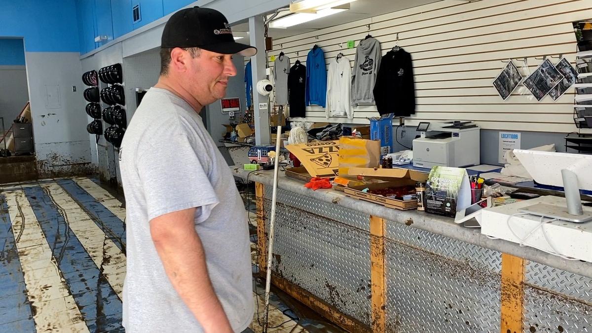 Jeff Babb, owner of Central Coast Cart Rentals in Morro Bay, looks at the mud line just under the counter top after his business was flooded. A break in the storm track on Jan. 10, 2023, allowed Babb to start cleaning his shop.