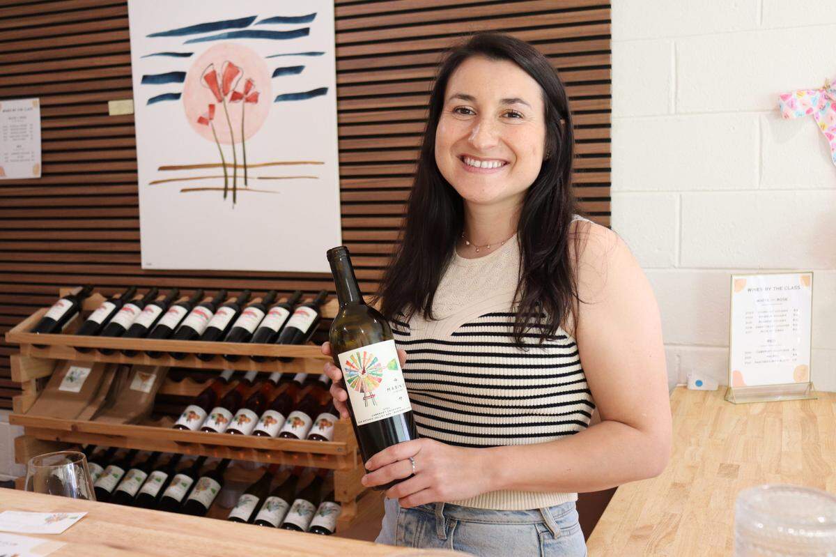Marin Wolgamott, the owner of Marin’s Vineyard, is pictured holding the wine label’s 2021 malbec in the winery’s new downtown Atascadero tasting room, which opened at 5983 Entrada Ave. in August 2024.