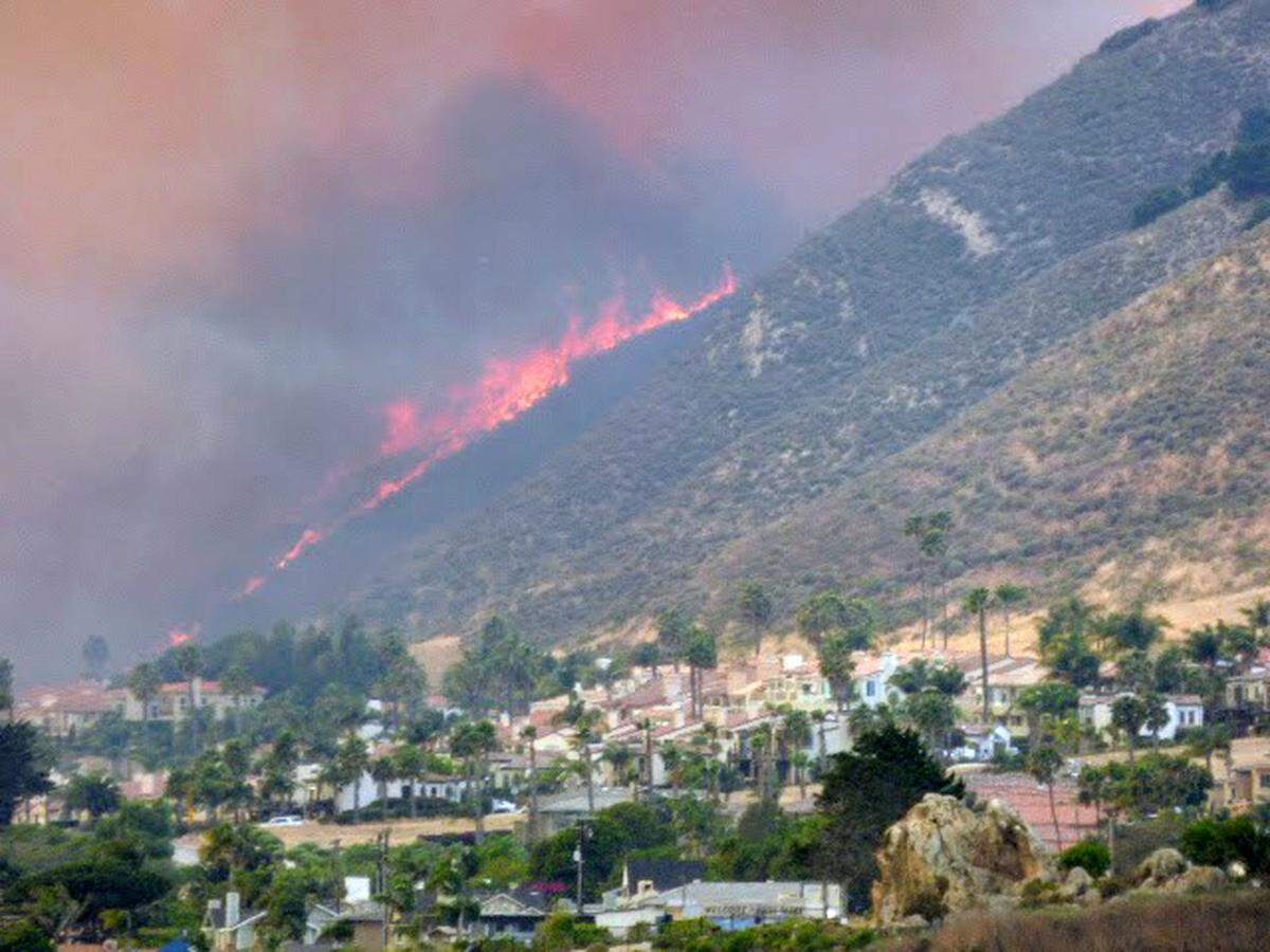 The Avila Fire burns in the hills above Shell Beach on Monday, forcing evacuations from nearby homes.