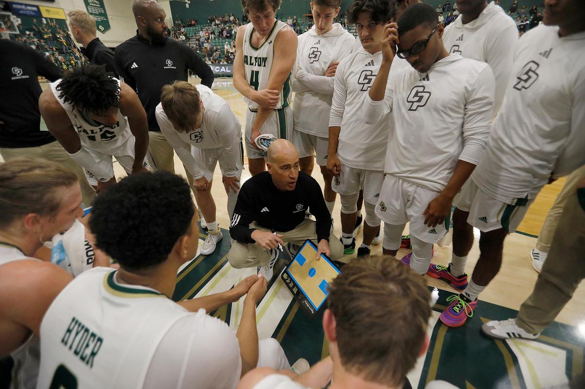 Cal Poly Head Coach Mike DeGeorge briefs the basketball team during a time-out. Cal Poly beat Seattle University 75-71 in a college basketball game at Mott Athletics Center on Nov. 14, 2024.