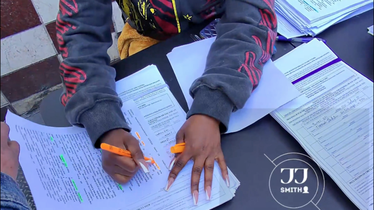A video posted by X user jj smith shows signature gatherers in San Francisco apparently paying people to sign petitions with false names and addresses, including those of a woman from Avila Beach.