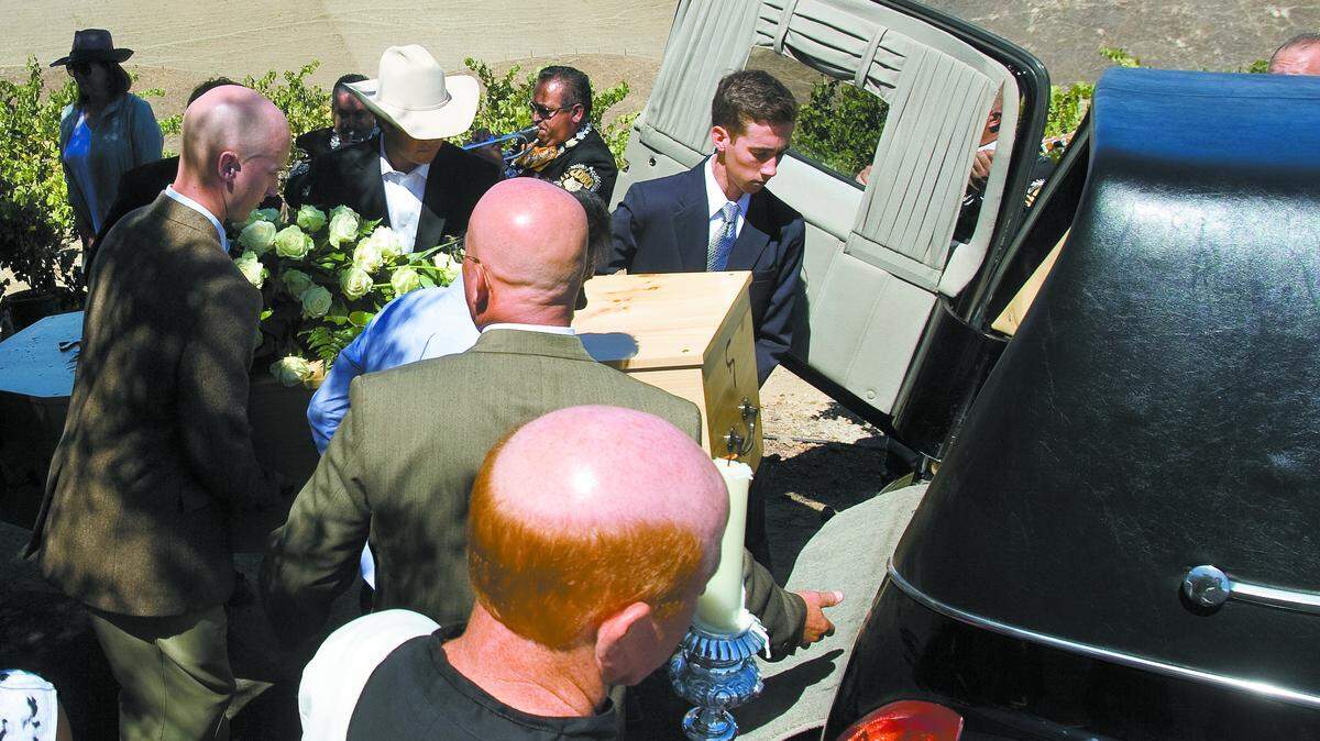 Pallbearers lift the simple pine casket as mariachi music plays after a memorial Mass for Judge William P. Clark on Wednesday at Chapel Hill in Shandon.