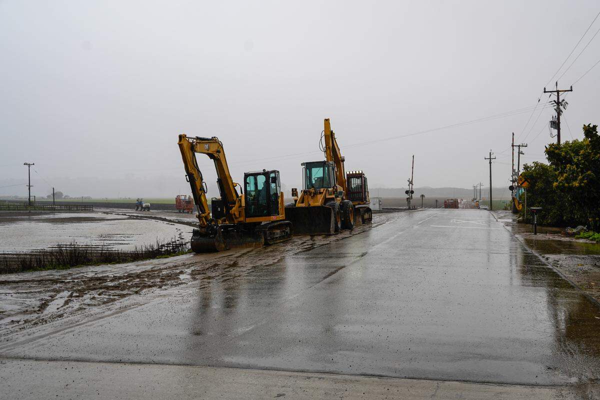 San Luis Obispo County Department of Public Works officials monitor the Arroyo Grande Creek Levee’s overflow levels on March 10, 2023.