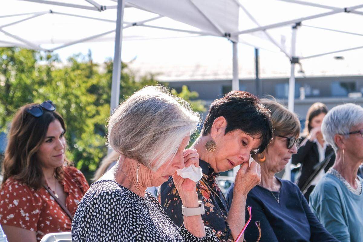 Pati Blevins (center) listens at the memorial for her daughter, Jennifer Besser, and her daughter’s boyfriend, Matthew Chachere, in San Luis Obispo on Oct. 21, 2023. The memorial was held on the 3400 block of Sacramento Drive, where Besser and Chachere were killed by a vehicle.