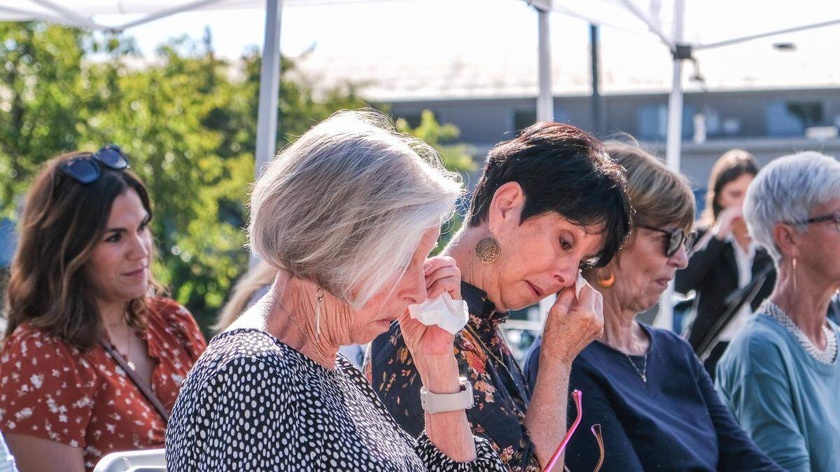 Pati Blevins (center) listens at the memorial for her daughter, Jennifer Besser, and her daughter’s boyfriend, Matthew Chachere, in San Luis Obispo on Oct. 21, 2023. The memorial was held on the 3400 block of Sacramento Drive, where Besser and Chachere were killed by a vehicle.