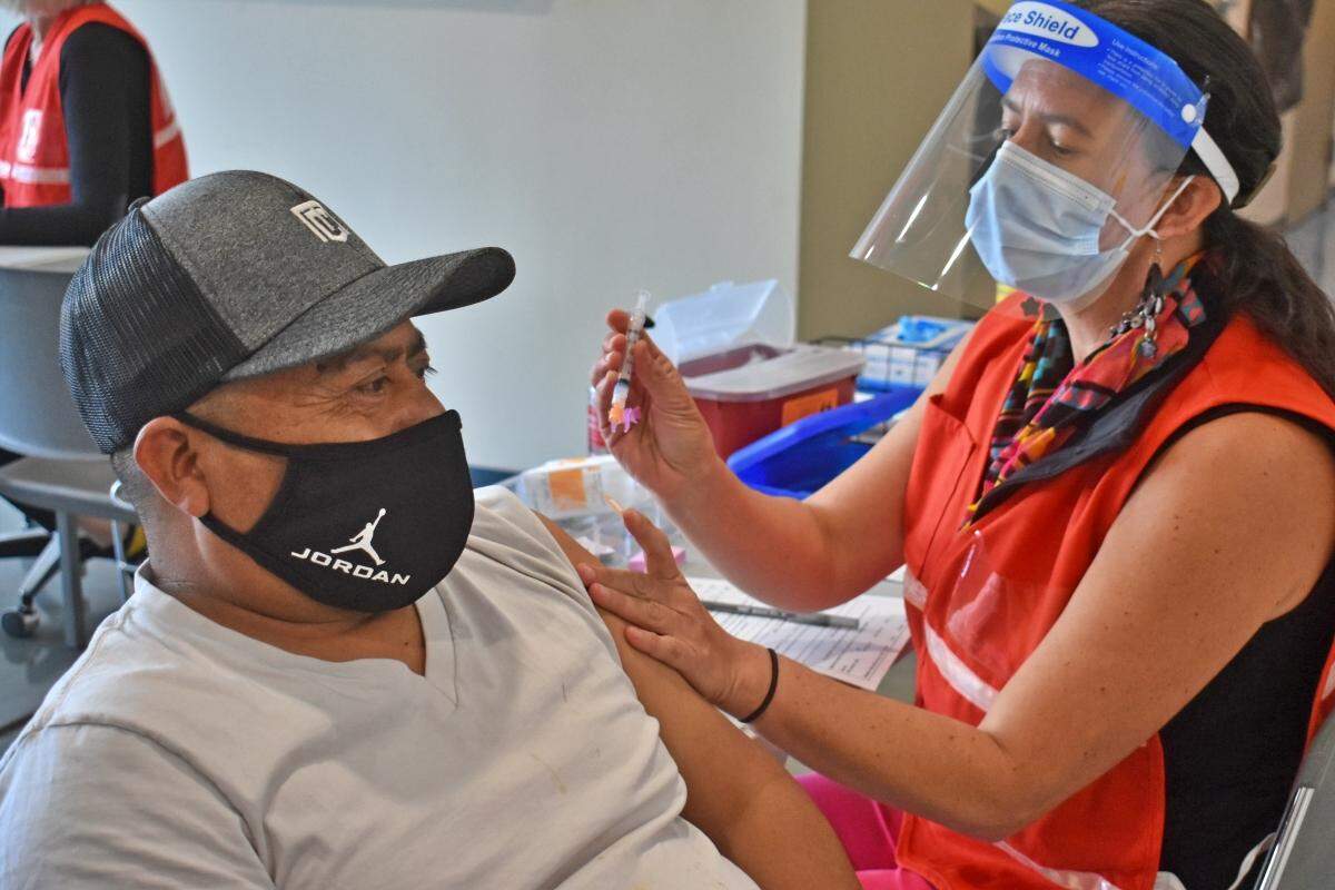Pedro Martinez, a Santa Barbara County agriculture worker, receives a COVID-19 vaccine from nurse Morena Loomis during a pilot coronavirus vaccination clinic hosted by the Santa Barbara County Public Health Department in Santa Maria. The county Public Health Department is opening vaccine appointments up to residents 16 and older.