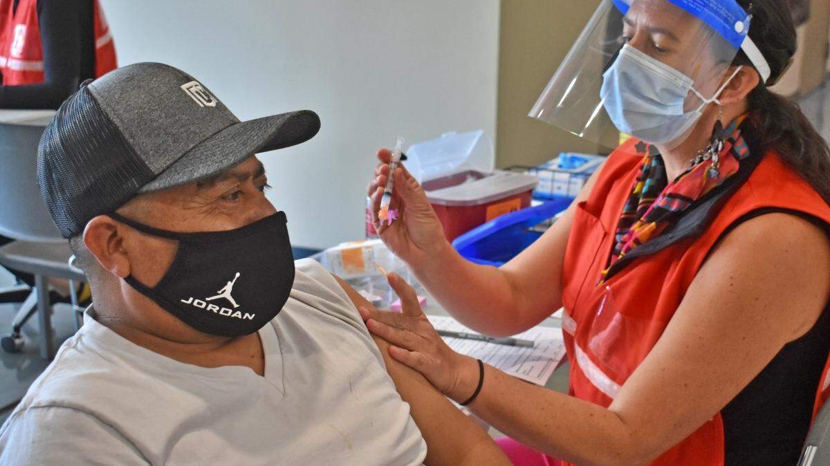 Pedro Martinez, a Santa Barbara County agriculture worker, receives a COVID-19 vaccine from nurse Morena Loomis during a pilot coronavirus vaccination clinic hosted by the Santa Barbara County Public Health Department in Santa Maria.
