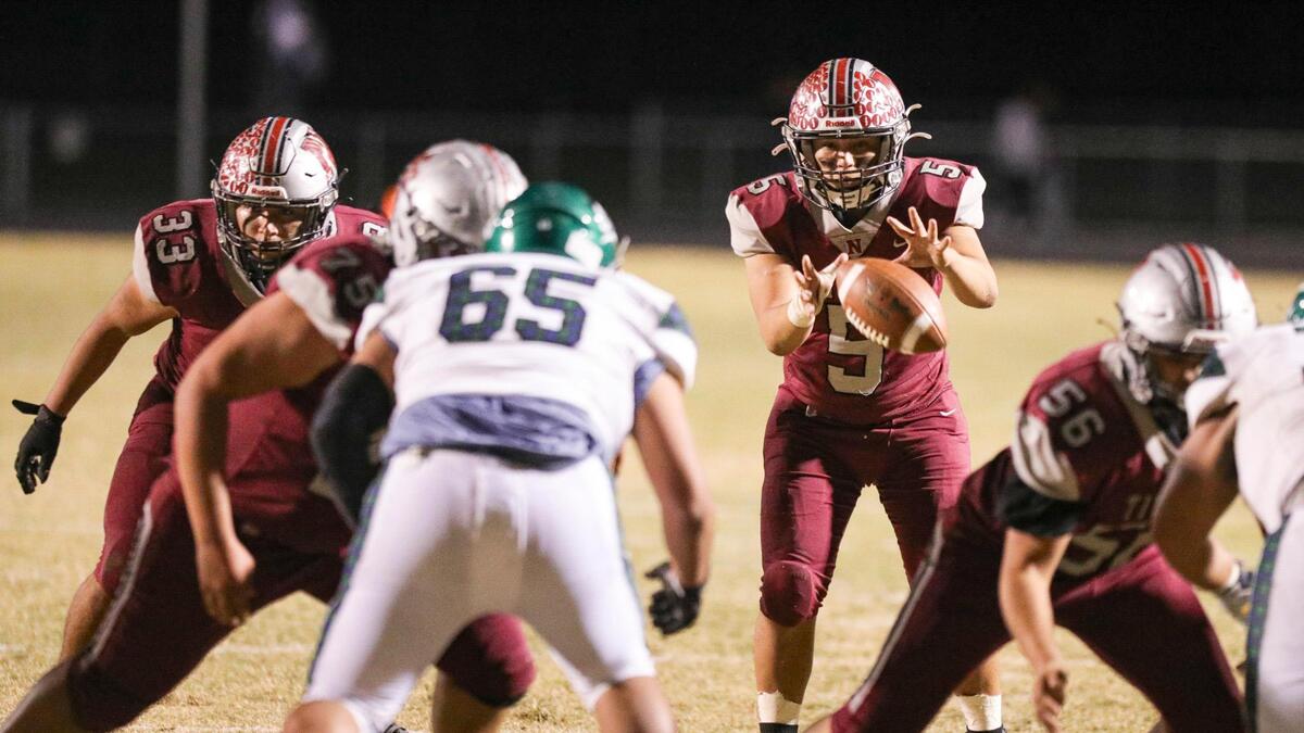 Gabe Evans takes the snap in the red zone. Nipomo fell to Highland 13-12 in the CIF-Central Section football playoffs on Nov. 12, 2021. Evans returns as one of the Titans’ team captains this year.