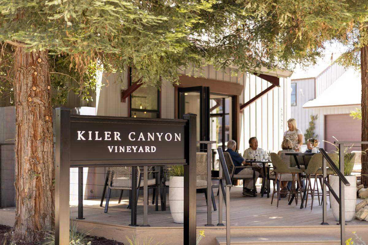 Kiler Canyon Vineyard’s new tasting room in Tin City includes a patio deck with lounge seating shaded by redwood trees.
