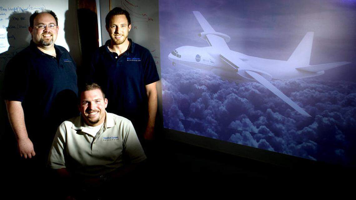 ESAero Inc. founders, clockwise from front, Andrew Gibson, Trevor Foster and Benjamin Schiltgen designed this prototype for a hybrid electric airplane that is about the size of a Boeing 737 and would carry 133 passengers.