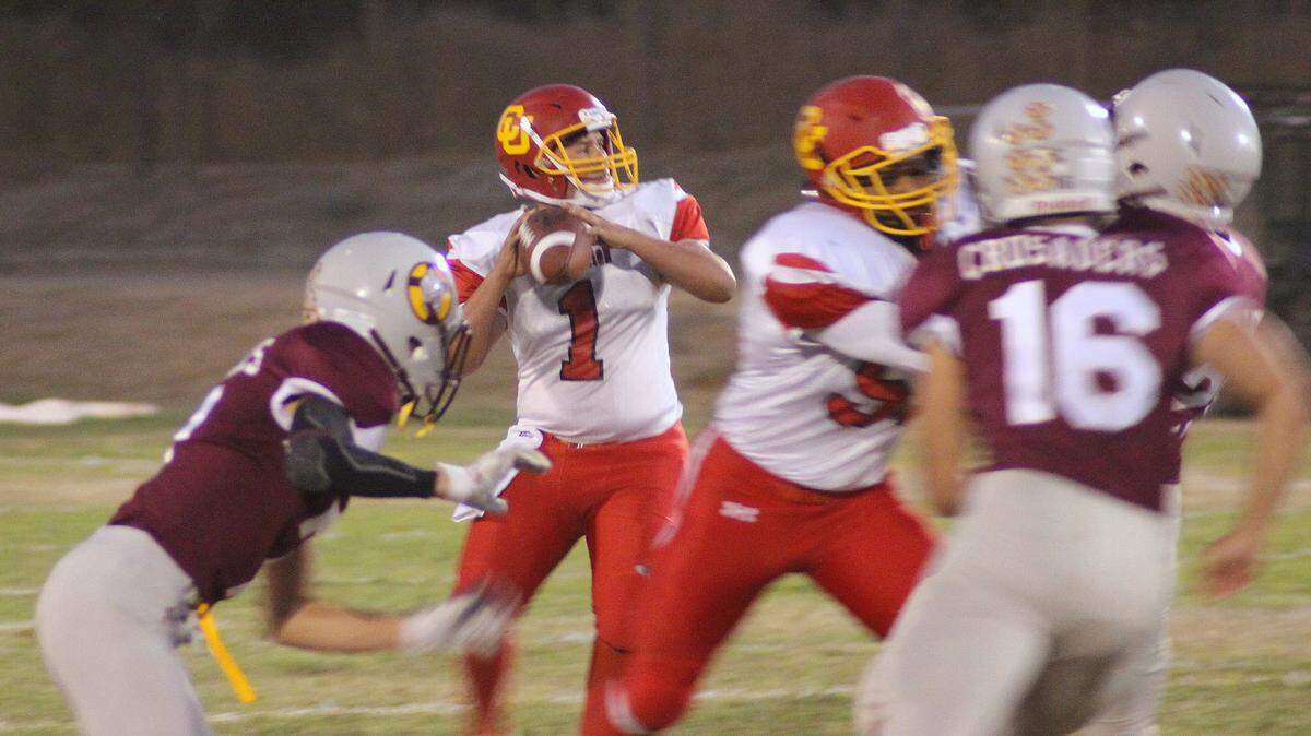 Coast Union High School quarterback Emany Plasencia passed for 138 yards and rushed for 65 yards, scoring three touchdowns Friday night in a win at Kings Christian. Here, he looks for his No. 1 receiver, Cristian Castillo, who caught three passes for 73 yards and scored two touchdowns.