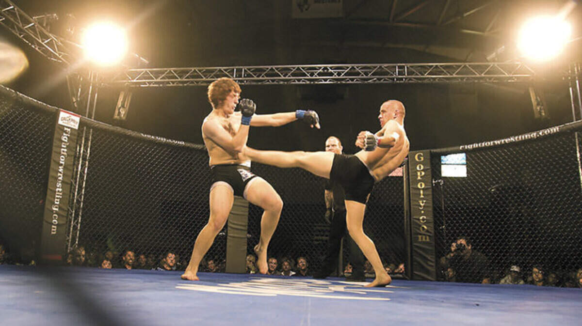 Cruz Gomez, right, kicks Eddie Hoch during the 1st round of their Pro Lightweight Bout of the Fight For Wrestling event at Mott Gym on Saturday night.
Nick Lucero  05-22-10