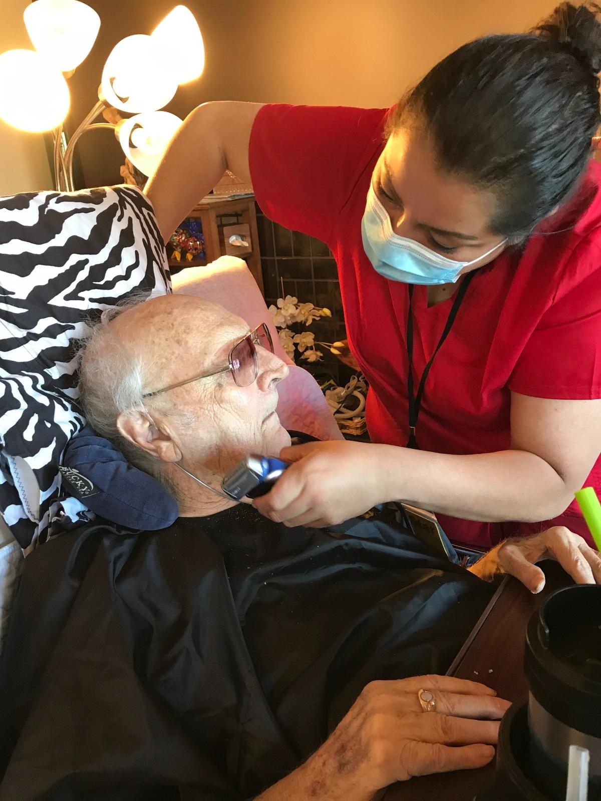 Commuter caregiver Lizette gives her client, Richard Tanner, a shave.