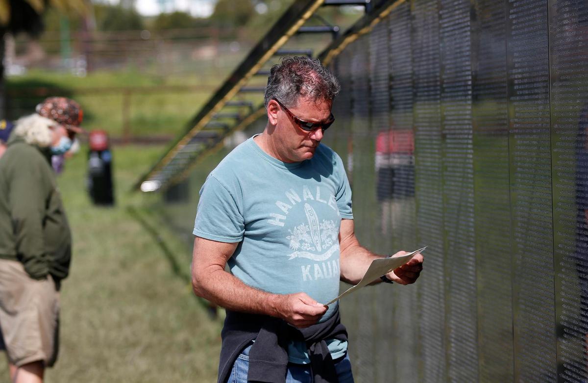 Dean Novotny of San Luis Obispo gets emotional reading a letter about a U.S. Army servicewoman who was killed in the Vietnam War, Lt. Sharon Lane, during a visit to traveling Vietnam War memorial The Wall That Heals in San Luis Obispo on Saturday, March 18, 2023.